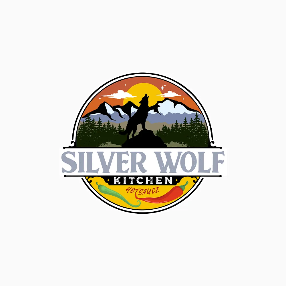The silver Wolf Spirit logo with a silhouette of a wolf howling on a mountain.